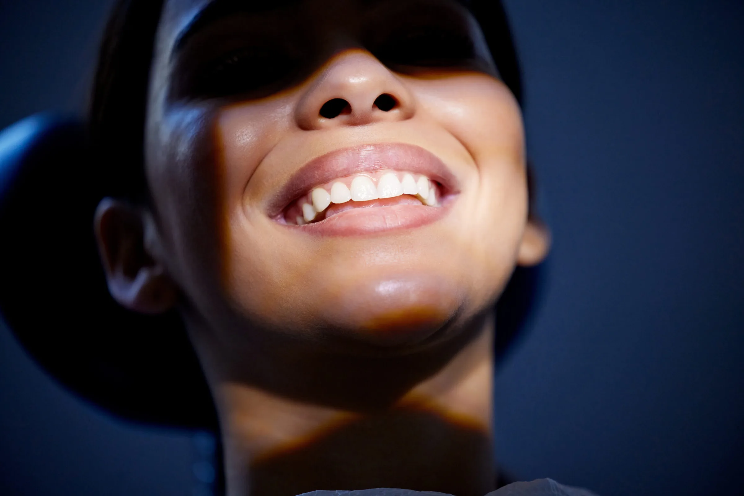 Young woman smiling in a dental chair (illustrative photo)